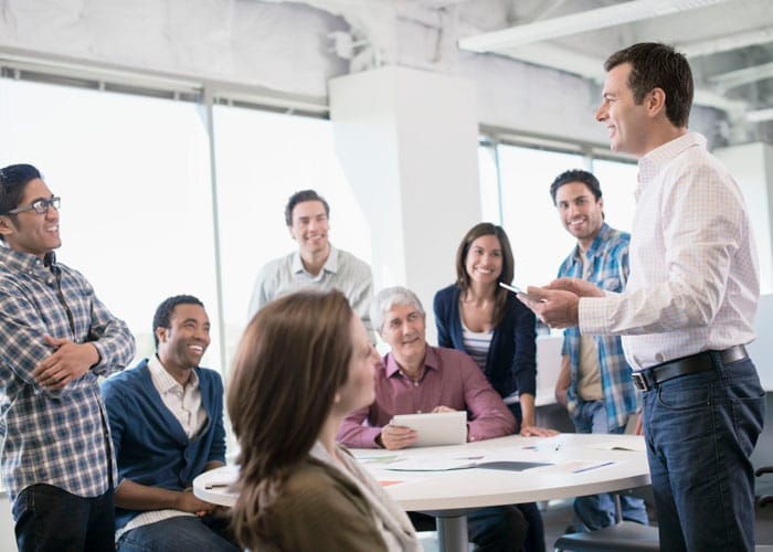 Colleagues having meeting in office --- Image by © Hiya Images/Corbis